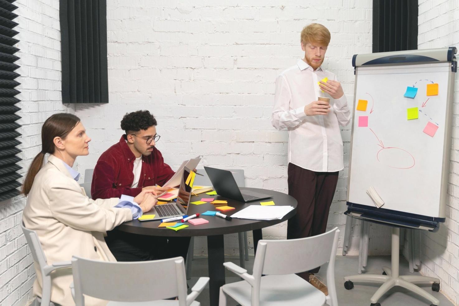 Modern office environment with financial analysts working on energy sector market research and data visualization